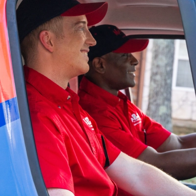 Two smiling Mr. Rooter employees.