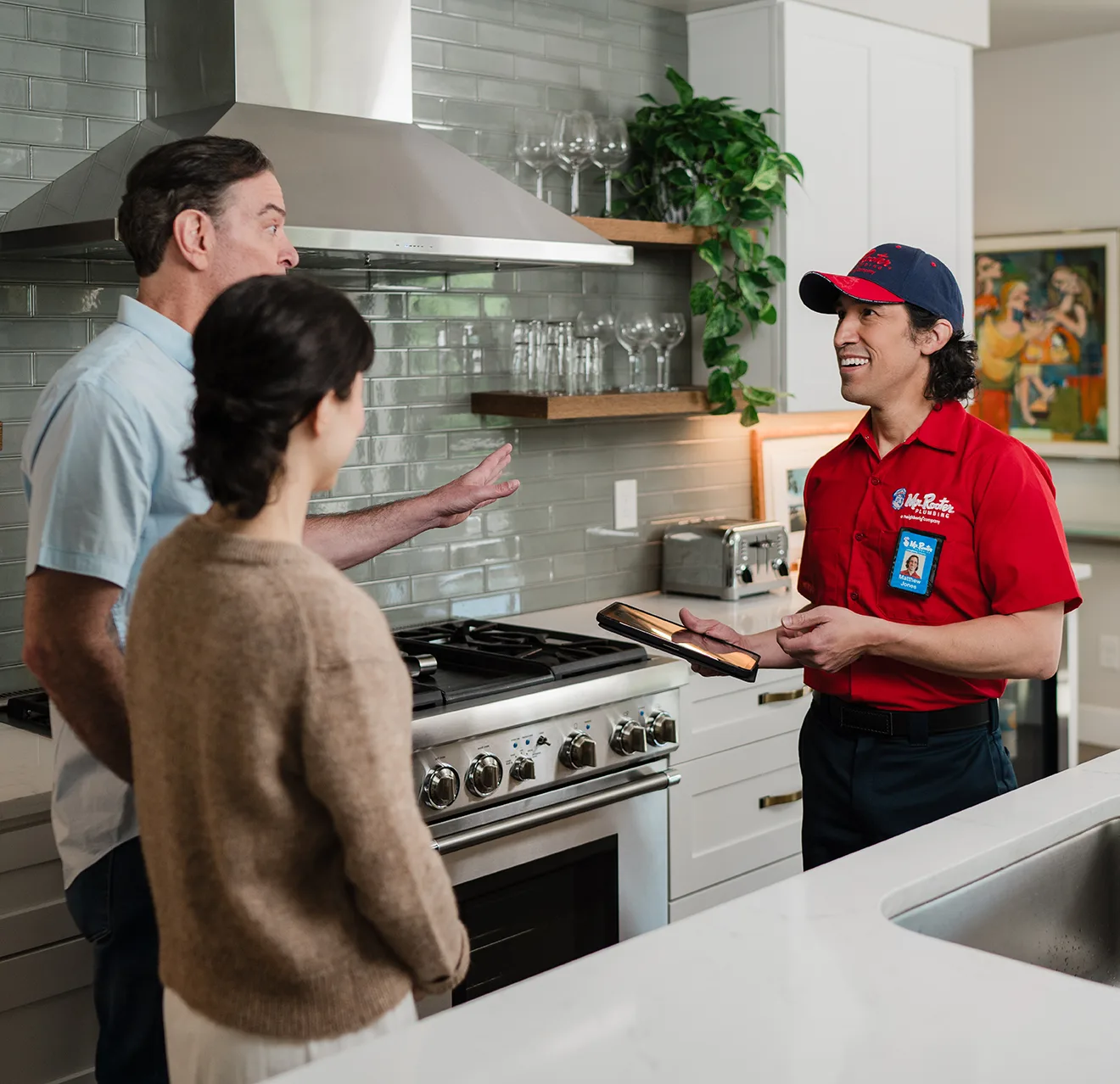 Mr. Rooter professional going over kitchen remodeling options with customers.