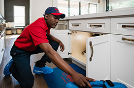 Mr. Rooter technician fixing a kitchen sink.