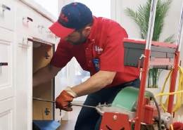 Mr. Rooter professional working on fixing a sink.