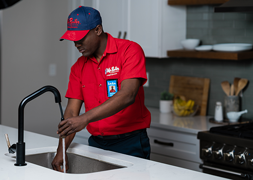 Mr. Rooter professional working on fixing a sink.