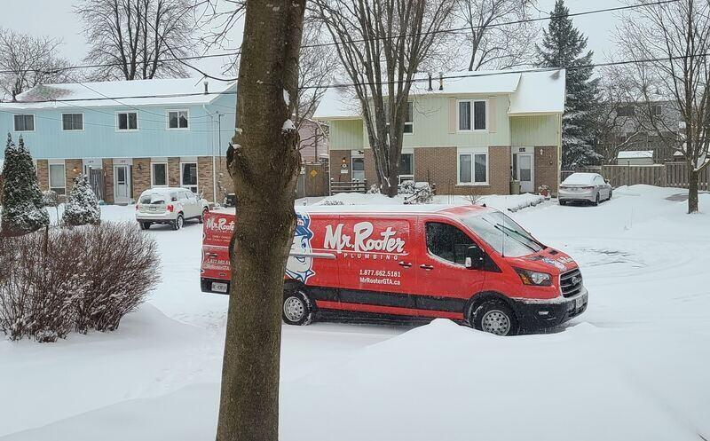 Marked van of Mr. Rooter Plumbing arriving to plumbing emergency in East Gwillimbury