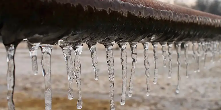 Icicles hanging from a pipe