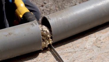 A sewer pipe in Mississauga, ON that a plumber has cut in half in order to remove blockage and repair the pipe.