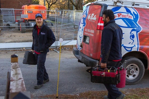 Mr. Rooter technician arriving at a site with an apprentice.
